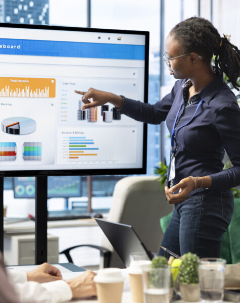 Advisory board members and team leaders gathering to review project outcomes, discuss resource allocation to ensure objectives achievement. Diverse business associates in a meeting.